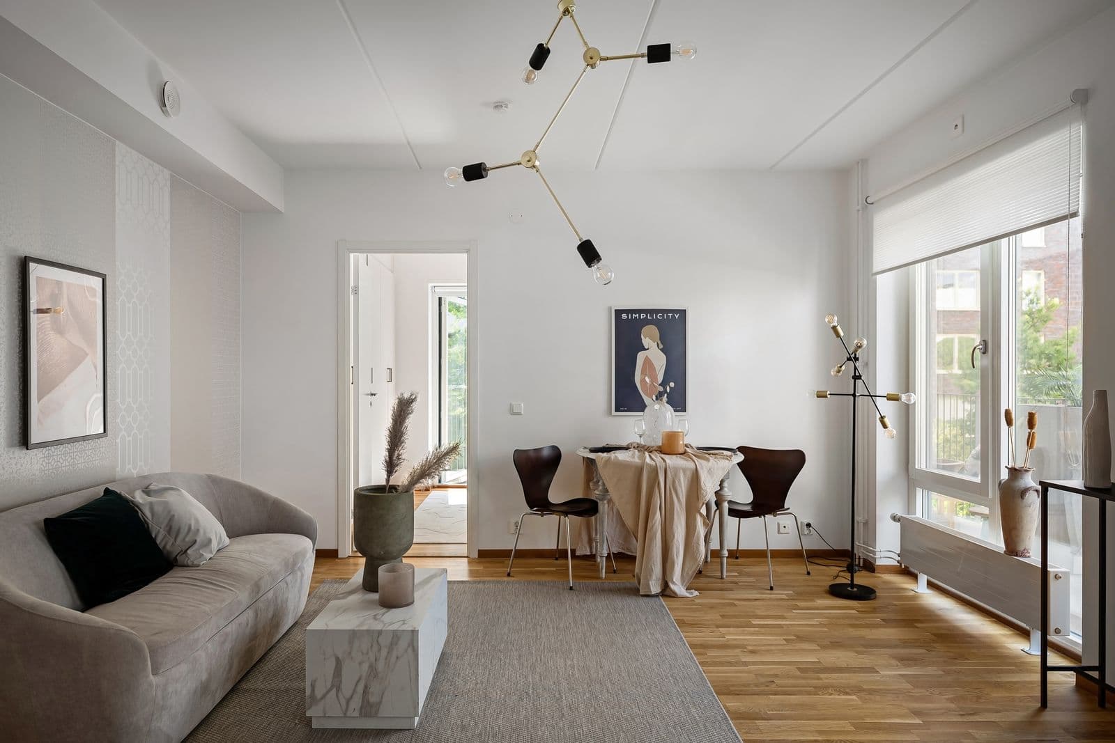 Bright, tidy living room in a Dublin apartment with red-brick buildings visible through the window