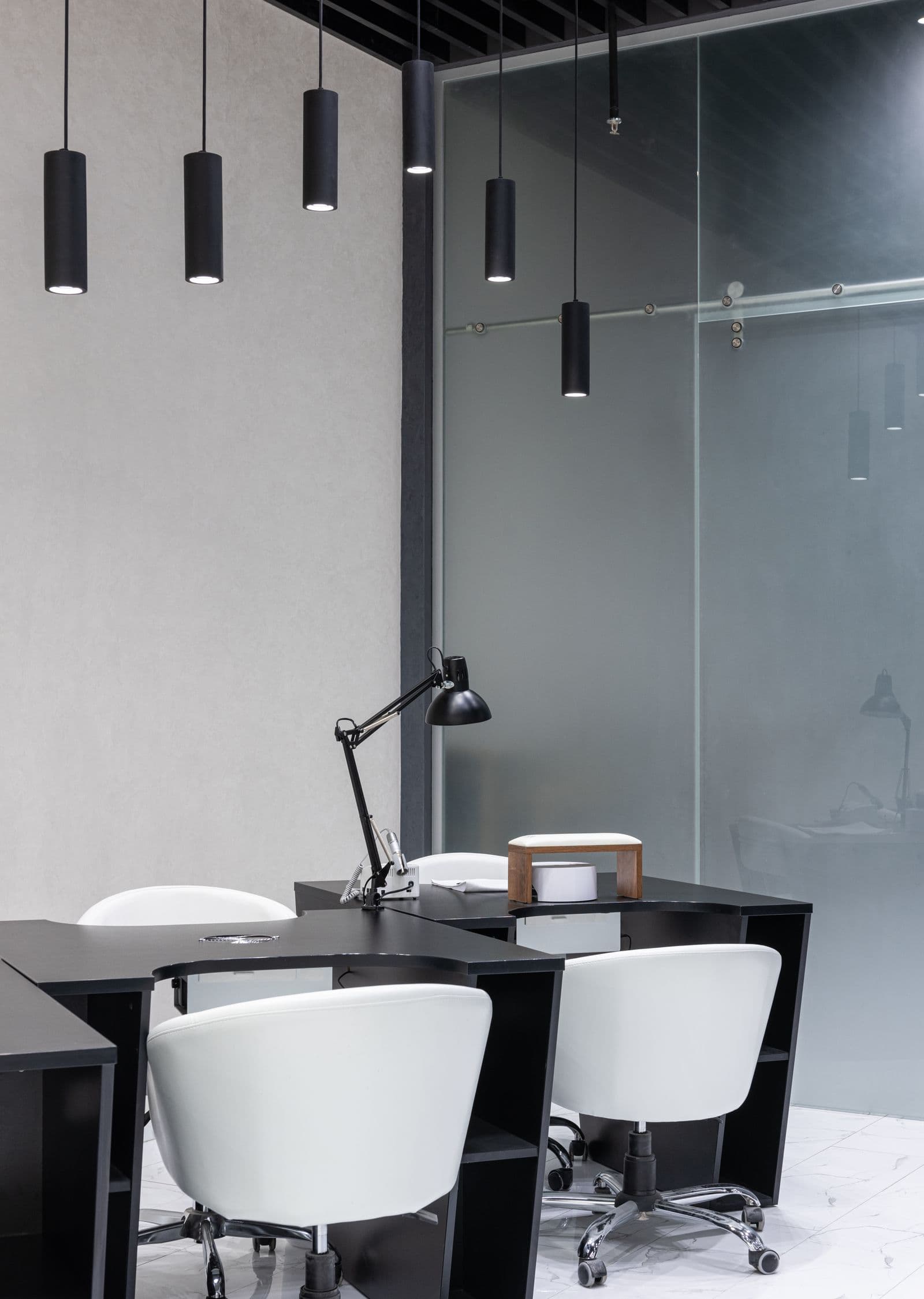 Sleek modern commercial interior with dark furniture and pendant lighting