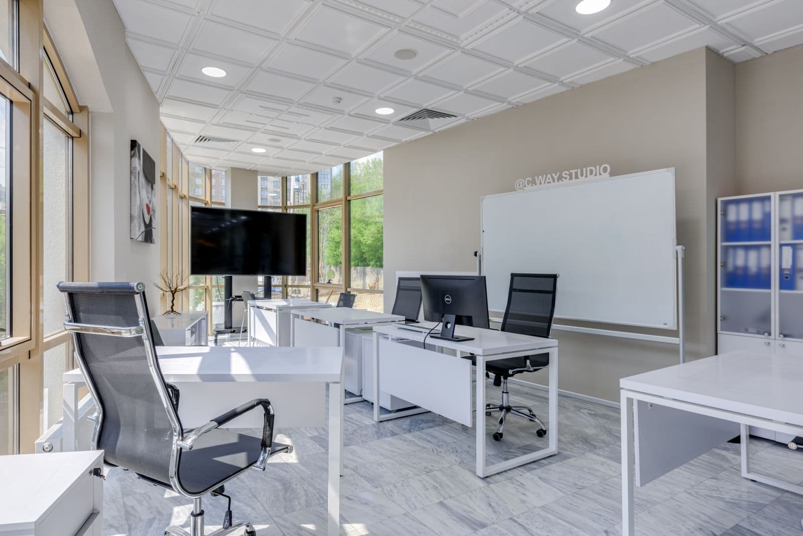 Spacious, bright modern office interior with clean workstations